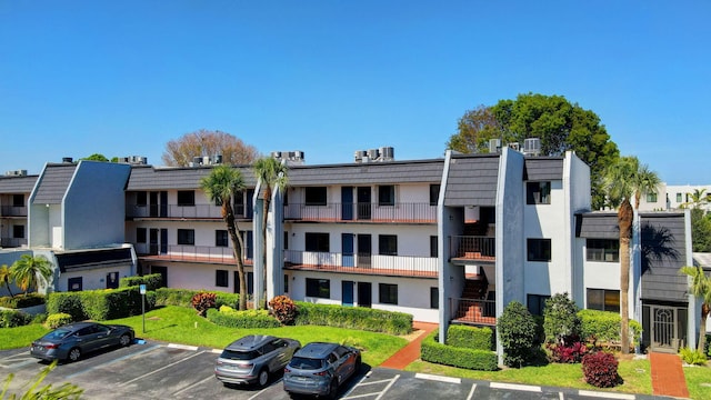 view of property featuring uncovered parking