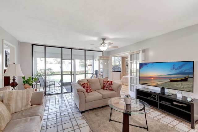 living room featuring a ceiling fan and light tile patterned floors
