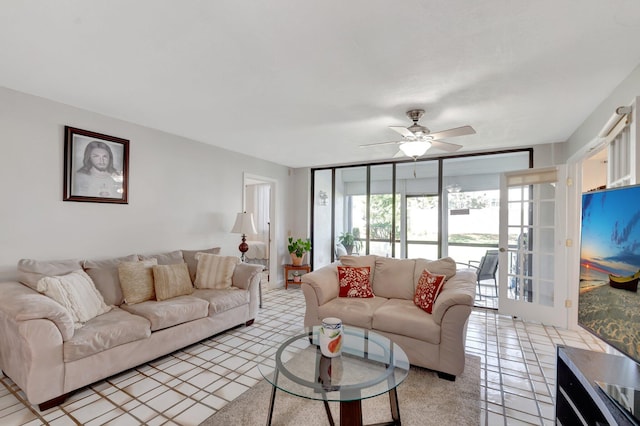 living area featuring a ceiling fan and light tile patterned flooring