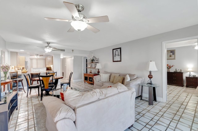 living room with a ceiling fan and baseboards