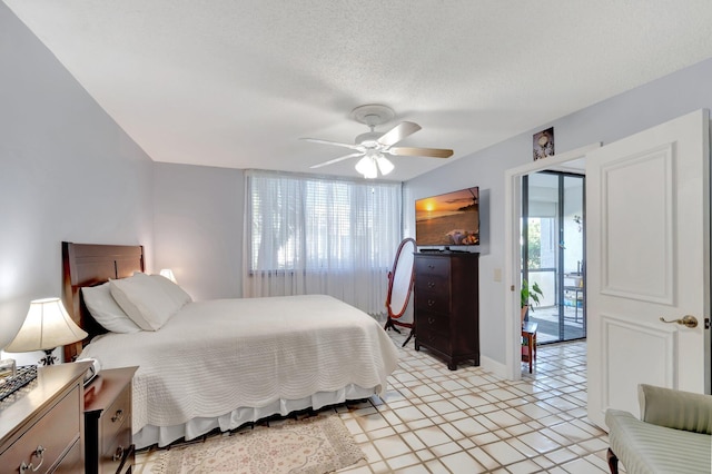 bedroom featuring ceiling fan, a textured ceiling, light floors, and baseboards