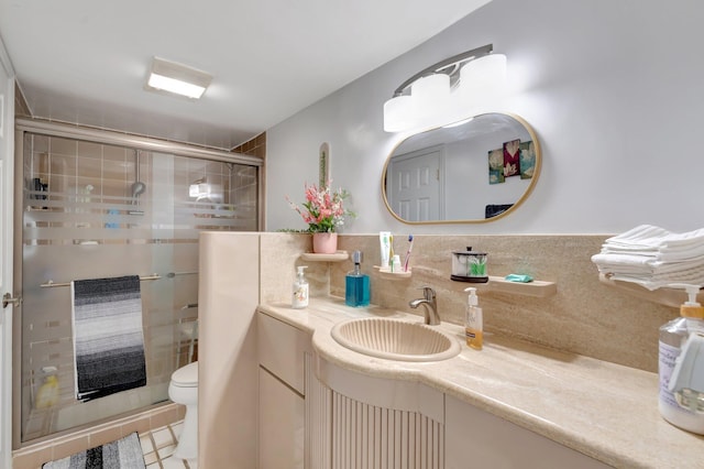bathroom featuring a stall shower, vanity, and toilet