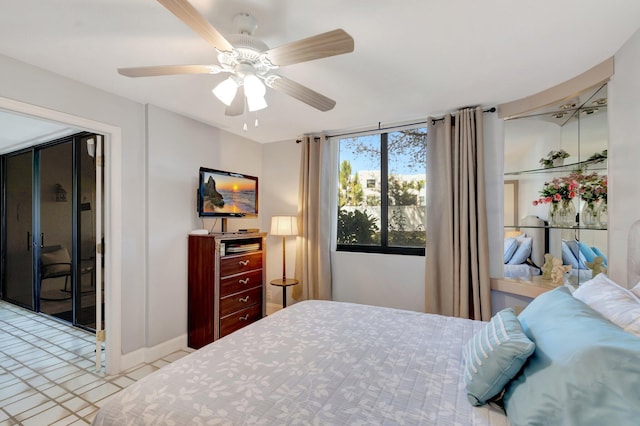 bedroom with ceiling fan and baseboards