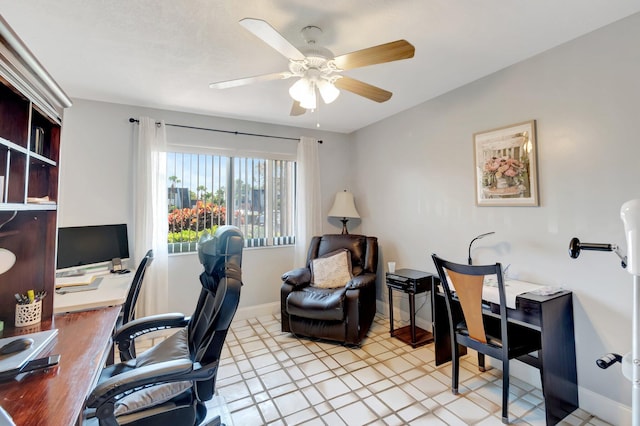 office area featuring a ceiling fan and baseboards
