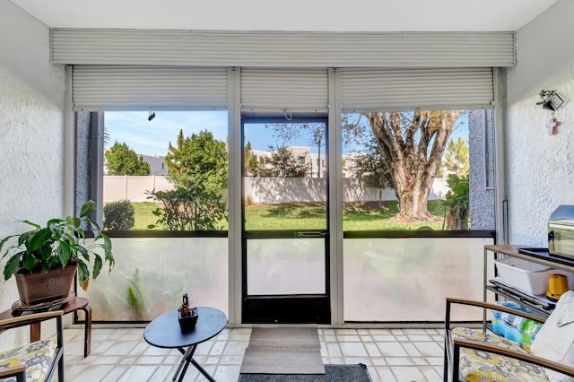 entryway with tile patterned floors and a textured wall