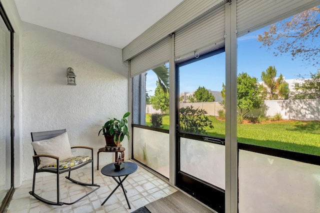 sunroom / solarium with a textured wall and tile patterned floors