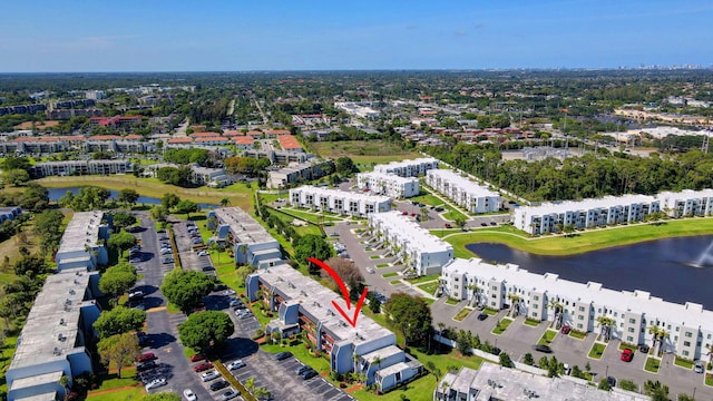 bird's eye view of apartment complex and a large body of water