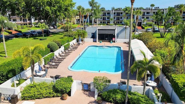 community pool with fence and a patio area