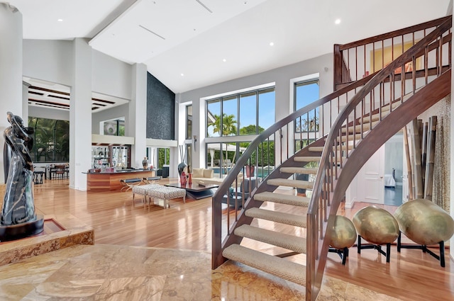 2393 NW 59th St, Boca Raton, FL 33496 - stairway featuring wood finished floors and high vaulted ceiling