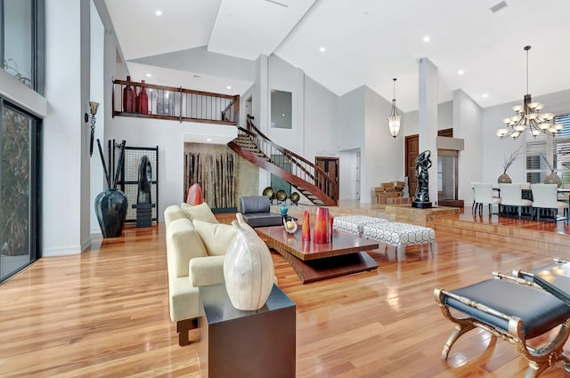 2393 NW 59th St, Boca Raton, FL 33496 - living room featuring wood finished floors, high vaulted ceiling, baseboards, a chandelier, and stairs