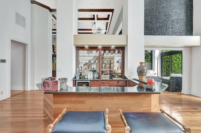2393 NW 59th St, Boca Raton, FL 33496 - interior space featuring wood finished floors, indoor wet bar, a towering ceiling, and wine cooler