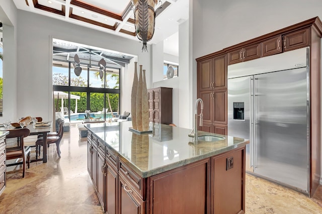 2393 NW 59th St, Boca Raton, FL 33496 - kitchen featuring a sink, stainless steel built in refrigerator, light stone counters, coffered ceiling, and a high ceiling