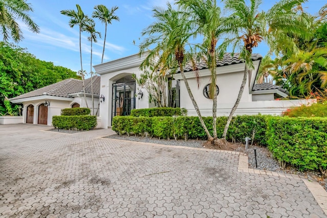2393 NW 59th St, Boca Raton, FL 33496 - mediterranean / spanish home with stucco siding, a tile roof, a garage, and decorative driveway