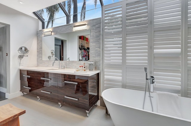 2393 NW 59th St, Boca Raton, FL 33496 - full bathroom with a skylight, tasteful backsplash, vanity, a freestanding bath, and baseboards