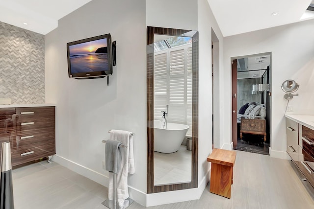 2393 NW 59th St, Boca Raton, FL 33496 - ensuite bathroom featuring vanity, ensuite bath, recessed lighting, a soaking tub, and baseboards