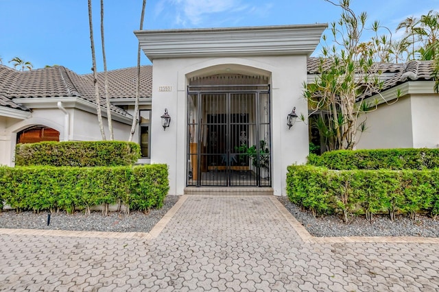 2393 NW 59th St, Boca Raton, FL 33496 - property entrance with stucco siding and a tile roof