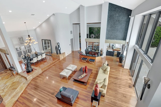 2393 NW 59th St, Boca Raton, FL 33496 - living room with light wood finished floors, recessed lighting, a chandelier, and high vaulted ceiling