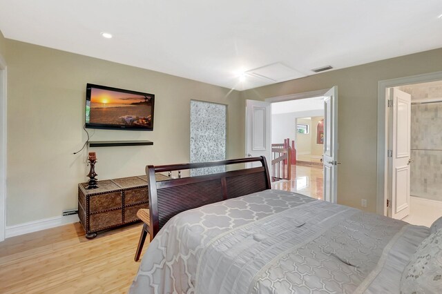 2393 NW 59th St, Boca Raton, FL 33496 - bedroom with attic access, baseboards, ensuite bathroom, light wood finished floors, and visible vents