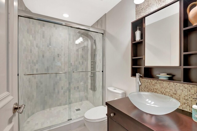 2393 NW 59th St, Boca Raton, FL 33496 - full bathroom with toilet, backsplash, vanity, and a stall shower