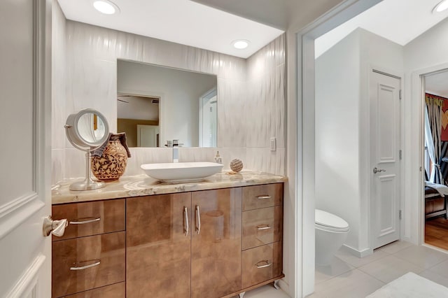 2393 NW 59th St, Boca Raton, FL 33496 - bathroom with toilet, tile patterned flooring, vanity, and recessed lighting
