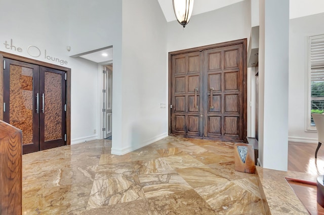 2393 NW 59th St, Boca Raton, FL 33496 - foyer entrance featuring baseboards, marble finish floor, and a high ceiling