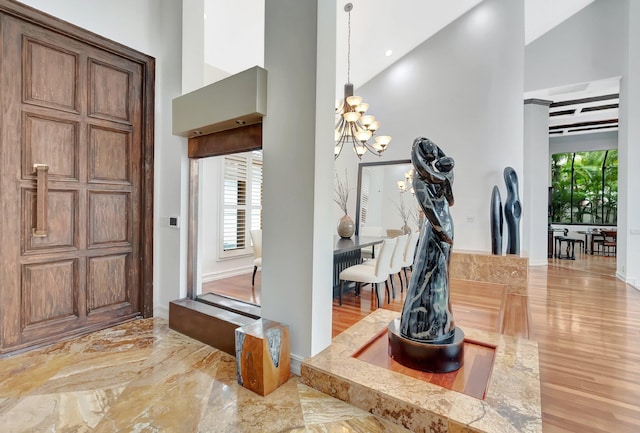 2393 NW 59th St, Boca Raton, FL 33496 - entryway featuring a chandelier, baseboards, and high vaulted ceiling