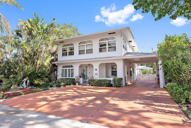 328 Monroe Dr, West Palm Beach, FL 33405 - view of front of property featuring driveway, a carport, stucco siding, a gate, and covered porch