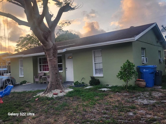 1441 W Central St, Lantana, FL 33462 - back of house at dusk with stucco siding and roof with shingles