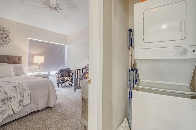 laundry area with laundry area, stacked washing maching and dryer, a ceiling fan, and carpet floors