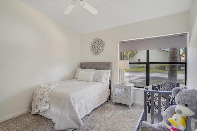 bedroom featuring baseboards, ceiling fan, and carpet floors
