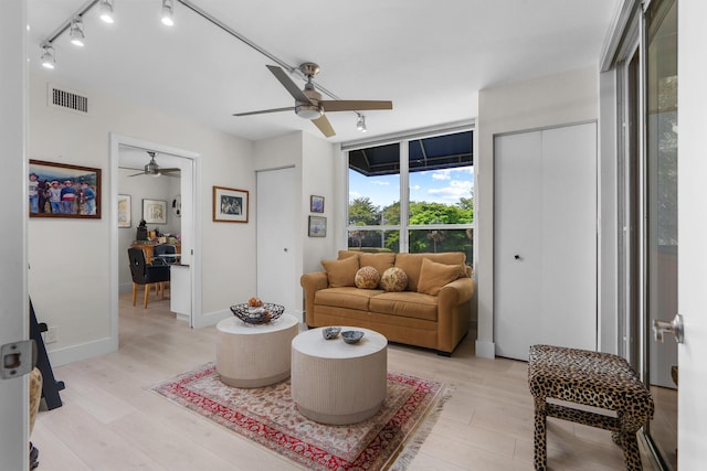 living area with ceiling fan, light wood-style floors, and track lighting