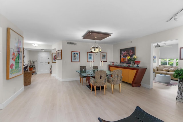 dining area with light wood finished floors, baseboards, and a ceiling fan