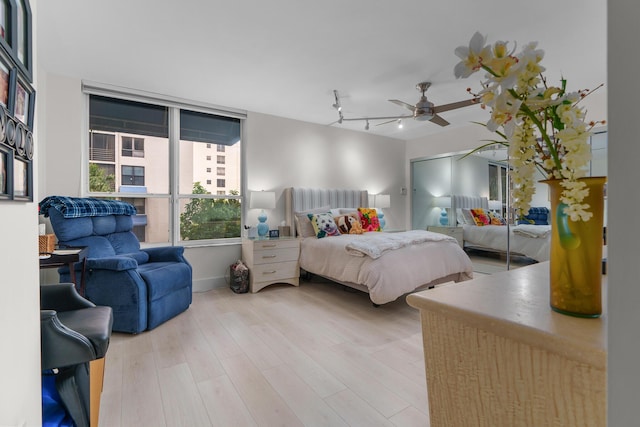 bedroom with wood finished floors, baseboards, and ceiling fan