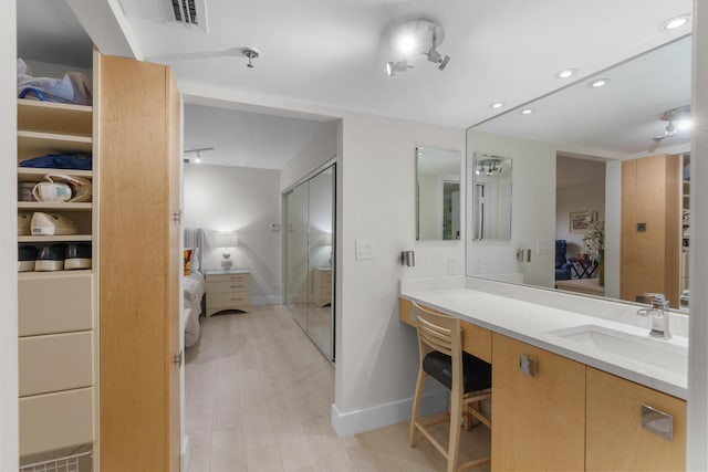 full bathroom featuring connected bathroom, baseboards, vanity, and recessed lighting