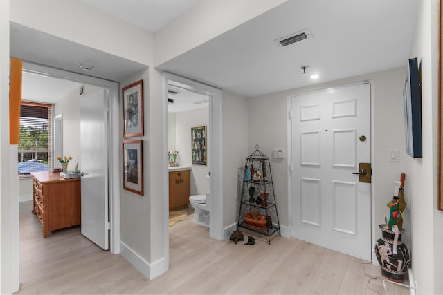 entrance foyer featuring light wood-type flooring and baseboards