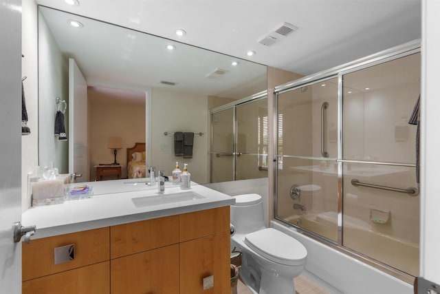bathroom featuring toilet, vanity, recessed lighting, shower / bath combination with glass door, and connected bathroom