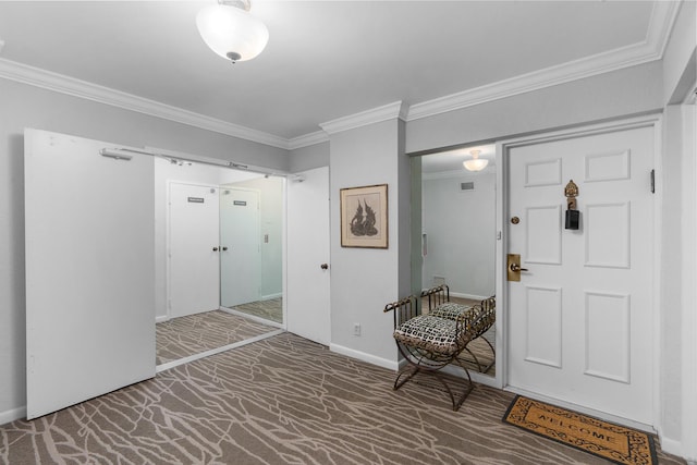 carpeted foyer with ornamental molding and baseboards