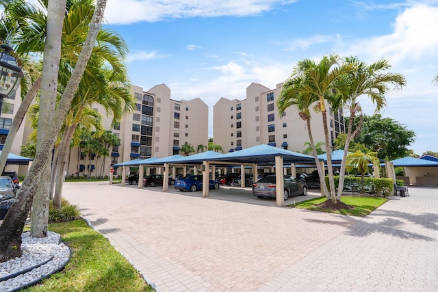 view of apartment building / complex with covered parking