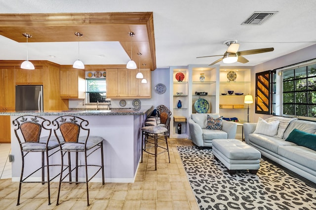 848 Johnson St, Hollywood, FL 33019 - kitchen featuring freestanding refrigerator, open floor plan, visible vents, and a kitchen bar