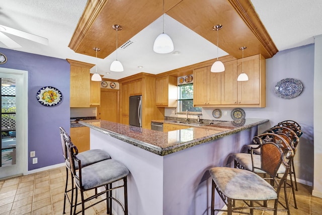 848 Johnson St, Hollywood, FL 33019 - kitchen featuring a breakfast bar area, baseboards, a sink, a peninsula, and stainless steel appliances
