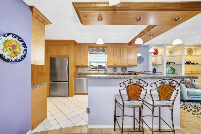 848 Johnson St, Hollywood, FL 33019 - kitchen featuring light tile patterned floors, a kitchen breakfast bar, appliances with stainless steel finishes, and decorative light fixtures