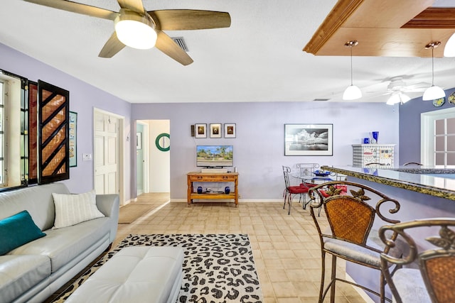 848 Johnson St, Hollywood, FL 33019 - living room with visible vents, baseboards, and a ceiling fan
