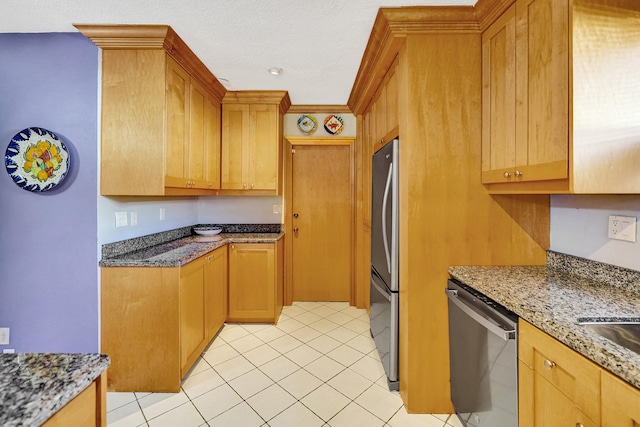 848 Johnson St, Hollywood, FL 33019 - kitchen featuring light tile patterned floors, stainless steel appliances, a textured ceiling, and light stone countertops