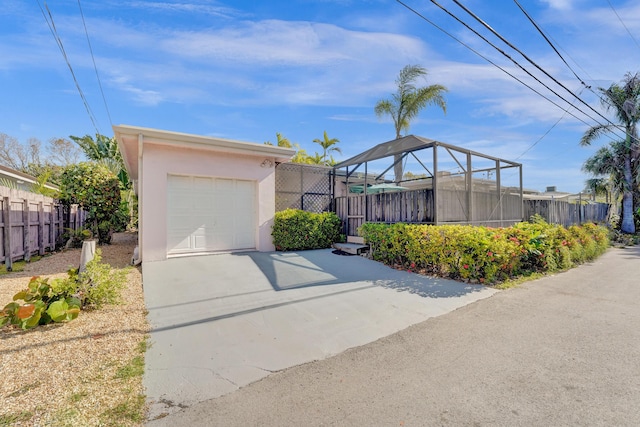 848 Johnson St, Hollywood, FL 33019 - view of front facade featuring concrete driveway, stucco siding, a garage, and fence
