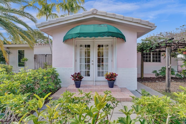 848 Johnson St, Hollywood, FL 33019 - entrance to property featuring brick siding, stucco siding, french doors, and fence
