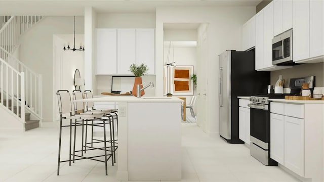 1531 Stockbridge St, Loxahatchee, FL 33470 - kitchen featuring a kitchen breakfast bar, a chandelier, light countertops, white cabinets, and appliances with stainless steel finishes