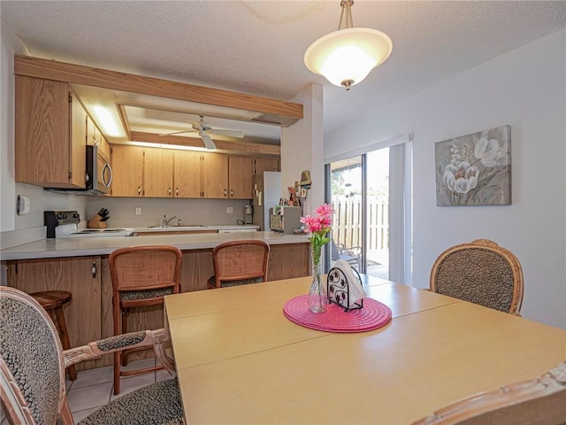 dining room featuring a ceiling fan and tile patterned floors