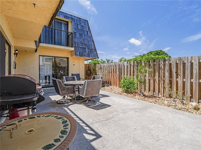 view of patio with outdoor dining space and a fenced backyard