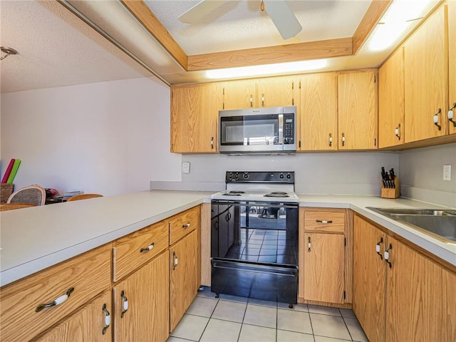 kitchen with stainless steel microwave, light countertops, a ceiling fan, light tile patterned floors, and electric range oven