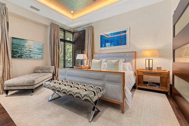 232 Bears Club Dr, Jupiter, FL 33477 - bedroom with a raised ceiling, visible vents, and wood finished floors